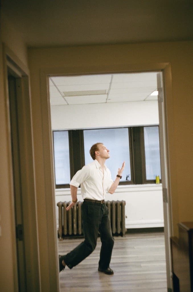 Rehearsal: actor in motion through a doorway