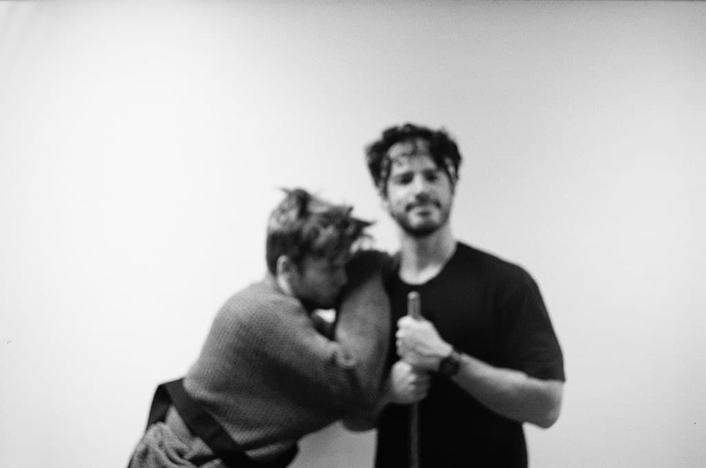 Rehearsal: two actors resting mid-session